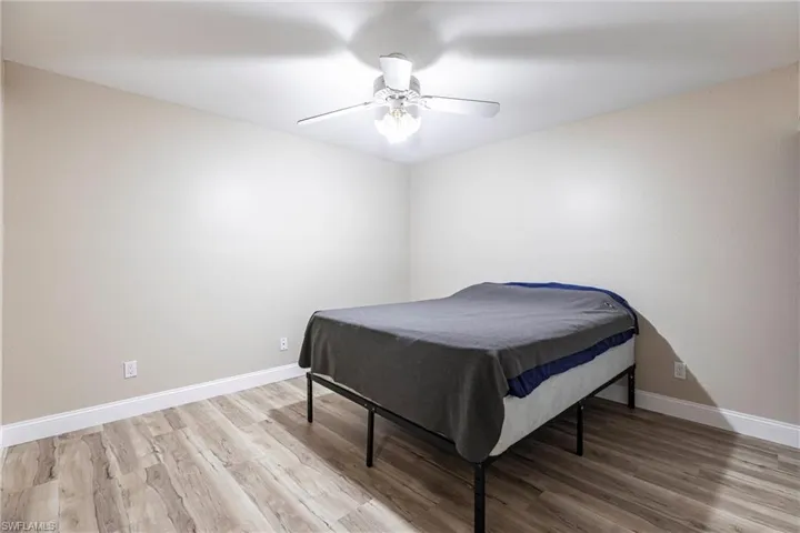 Bedroom featuring wood finished floors and ceiling fan