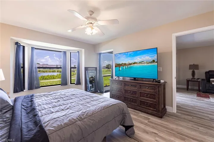 Bedroom with light wood-style flooring and a ceiling fan