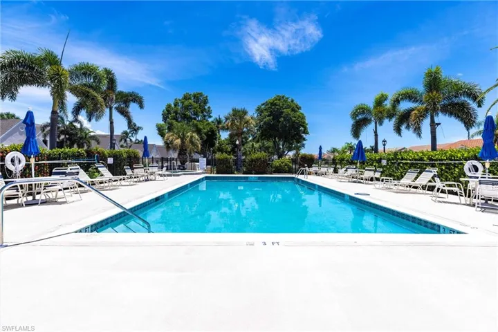 Community pool with a patio