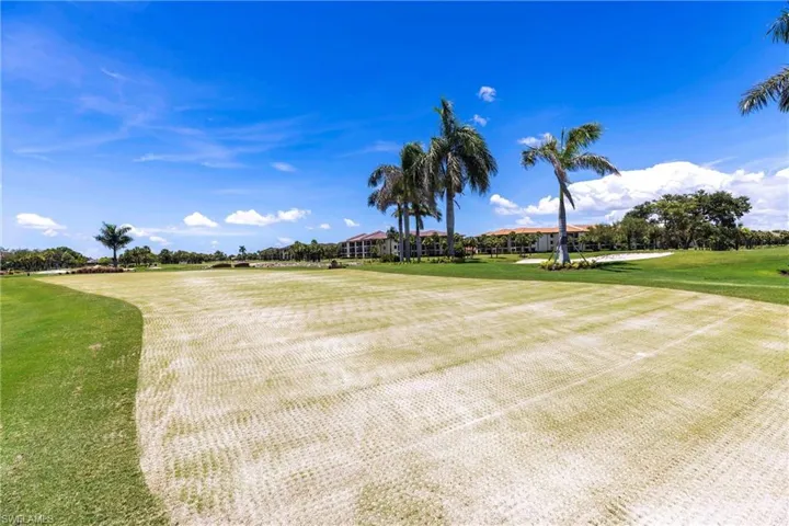 View of home's community with golf course view and a yard