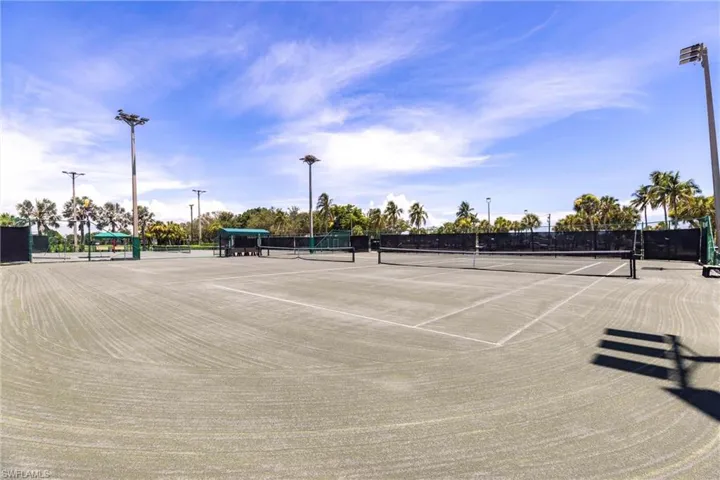 View of tennis court with community basketball court