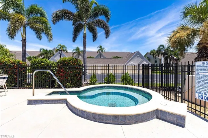View of swimming pool featuring a community hot tub