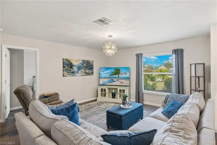 Living room with a chandelier and hardwood / wood-style floors