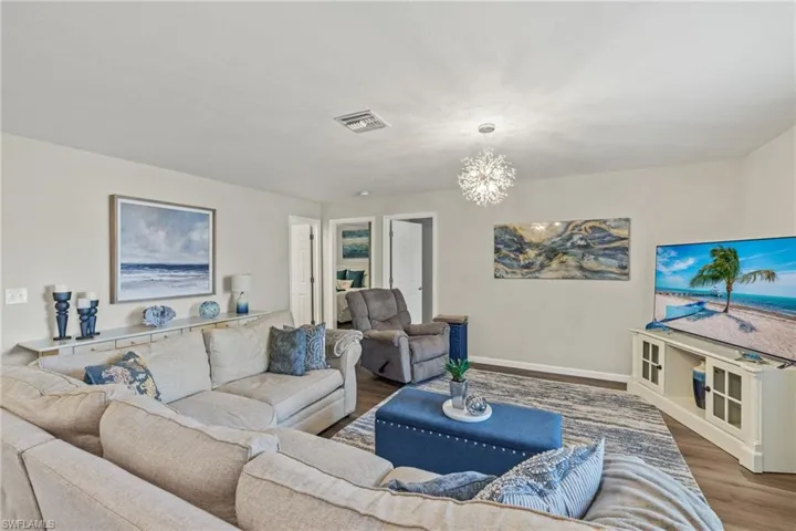 Living room featuring hardwood / wood-style flooring and a chandelier