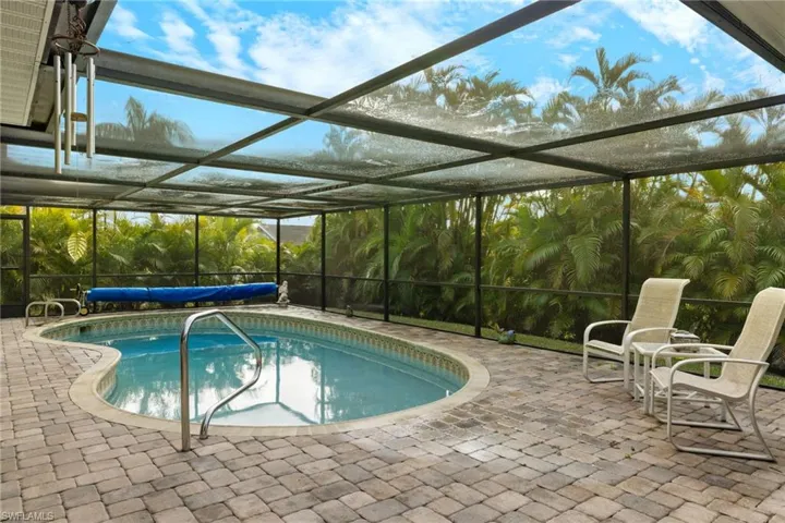 View of patio featuring ceiling fan and glass enclosure