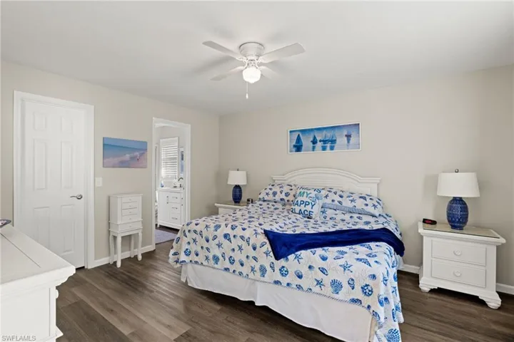 Bedroom with ceiling fan and dark hardwood / wood-style floors