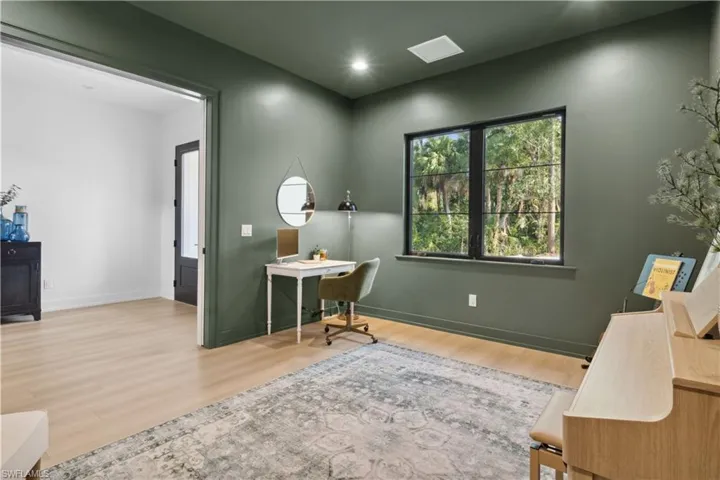 Office with wood finished floors and baseboards