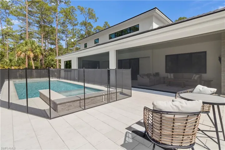 View of swimming pool featuring a patio and an outdoor hot tub