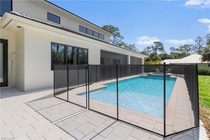View of pool with a patio area and a pool with connected hot tub