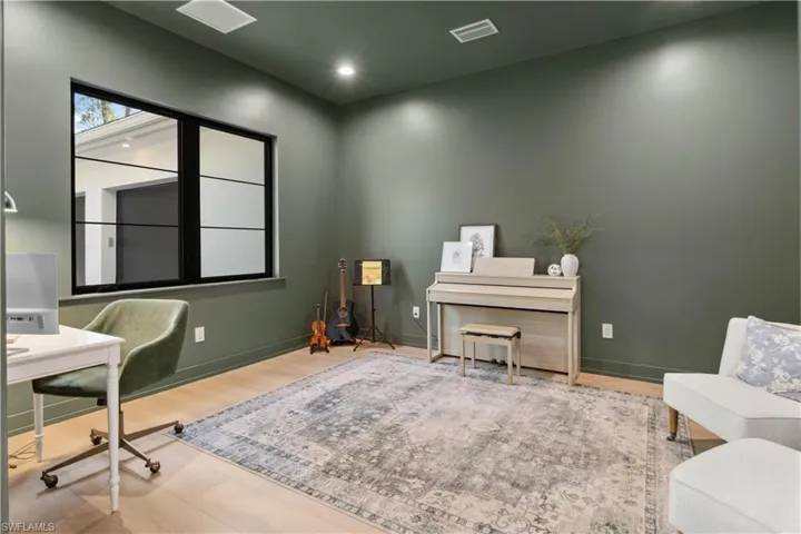 Home office with wood finished floors, baseboards, and recessed lighting