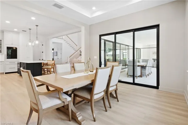 Dining area with stairway, light wood-style flooring, recessed lighting, and baseboards