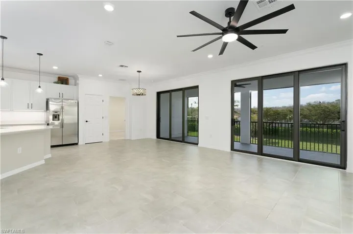 Unfurnished living room with crown molding, recessed lighting, visible vents, a ceiling fan, and baseboards
