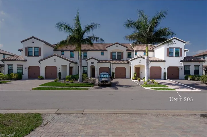 Mediterranean / spanish-style home featuring decorative driveway, an attached garage, and a tile roof