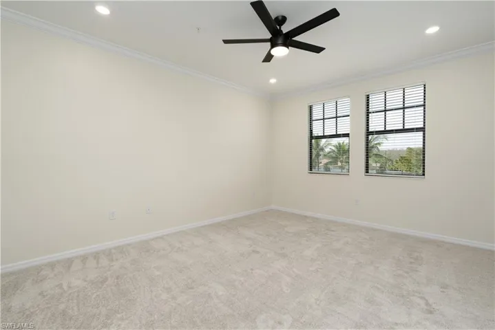 Unfurnished room featuring baseboards, ornamental molding, and recessed lighting