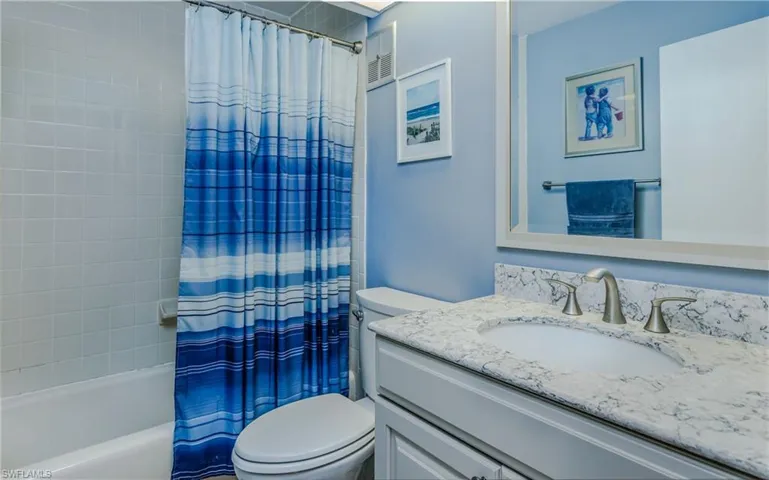 Full bathroom featuring vanity, toilet, and shower / tub combo