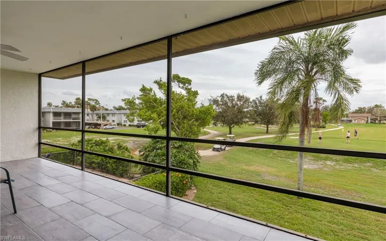 Unfurnished sunroom with ceiling fan