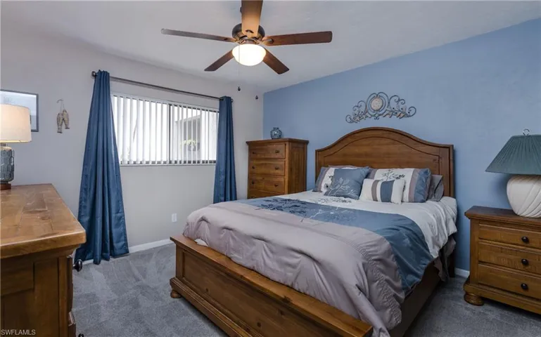 Bedroom with ceiling fan and carpet flooring