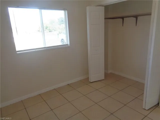 Guest bedroom 2 with closet and light patterned flooring