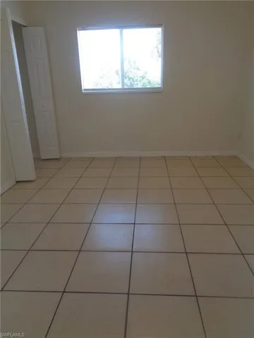 Guest bedroom 1 with closet and light patterned flooring