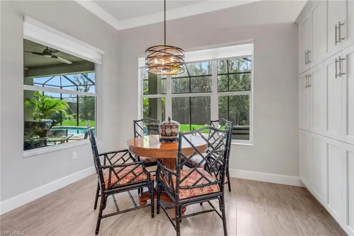 Dining area with a sunroom, ceiling fan, and baseboards