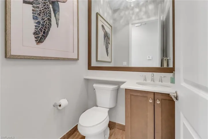 Bathroom with baseboards, vanity, and toilet