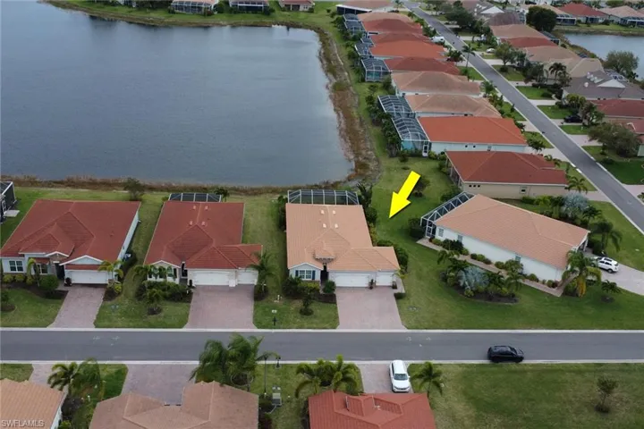Front Aerial view featuring lake view and large private setting