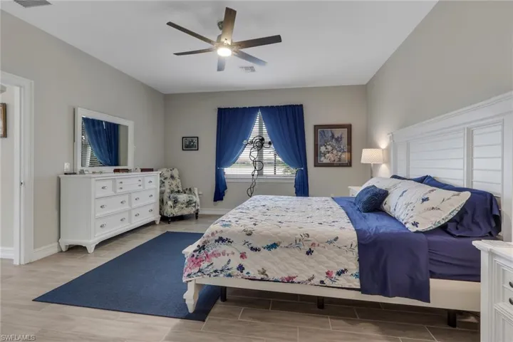 Bedroom with tiled floors and a ceiling fan