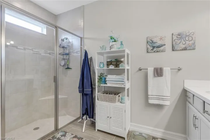 Full bath featuring large tiled shower, and tiled floors