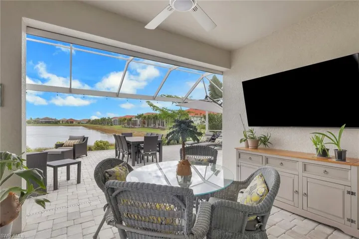 View of covered lanai overlooking the lake view. Covered lanai has power hurricane screens.
