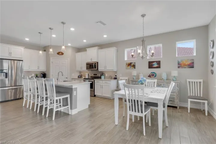 Dining area with suspended lighting and tiled floors