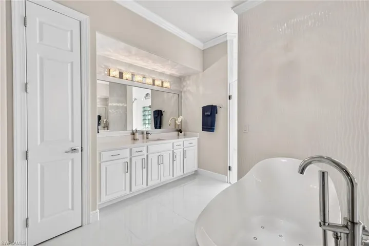 One of two vanities both with linen closets for extra storage.