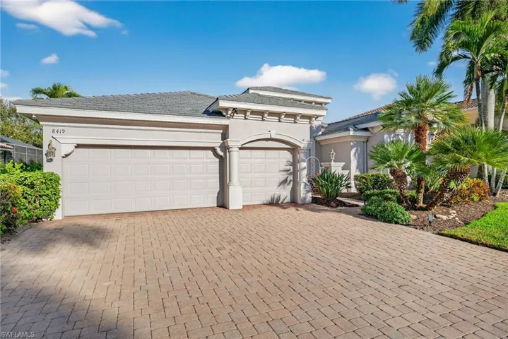 Three car garage featuring mini split a/c, insulated garage door and an EV charging outlet.