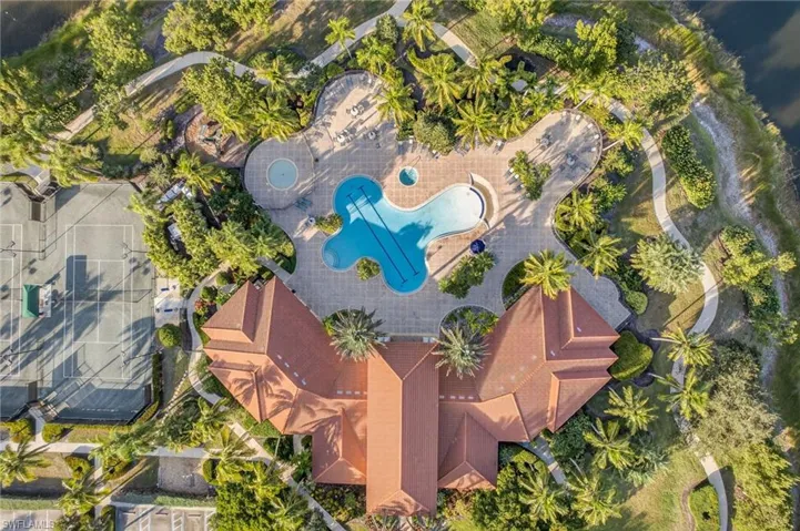 Aerial view of clubhouse and resort zero entry pool, kids pool, spa and playground.
