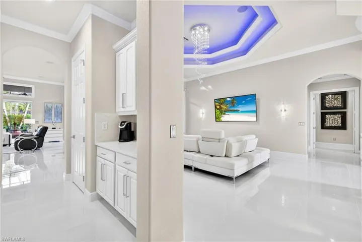 Butler Pantry pass through from formal dining area to kitchen and family room. Featuring quartz counter tops and pantry.  Dimensional white accent wall not shown.