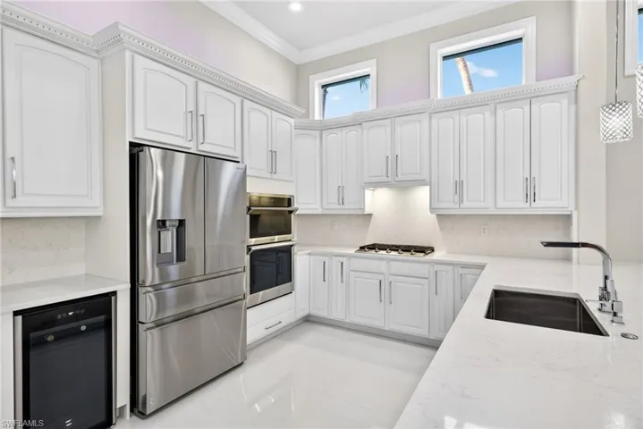 Upgrade stainless steel appliances including wall oven and wine cooler.  Clerestory overhead windows add natural light and privacy.