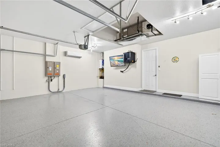 Three car garage with mini split. EV charging outlet, security center / TV and tankless water heater.