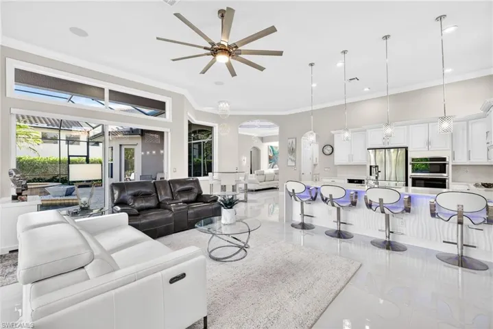 Family room view looking out to lanai and living area.  Sliding doors feature roll-down blinds.
