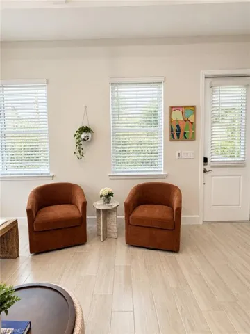 Wood-finish plank flooring, white interior walls, and white trim throughout