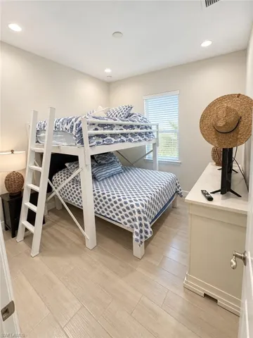 Recessed lighting, wood-finish flooring, and window with blinds