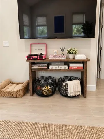 Wall-mounted television with a wood-finish console table