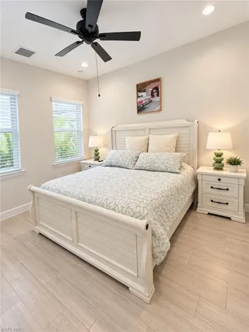 Wood-finish flooring, recessed lighting, ceiling fan, and window with blinds