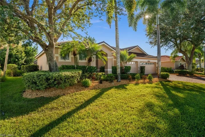 View of front of HOME with stucco siding, a front yard, decorative driveway, and 3 car garage