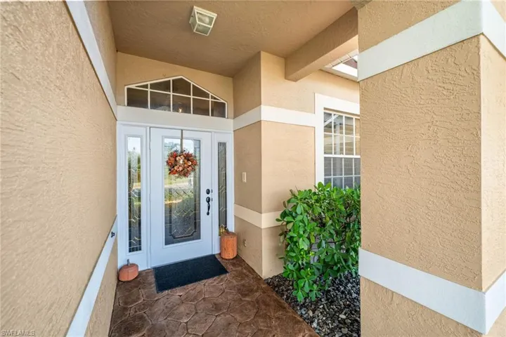 View of exterior entry with stucco siding