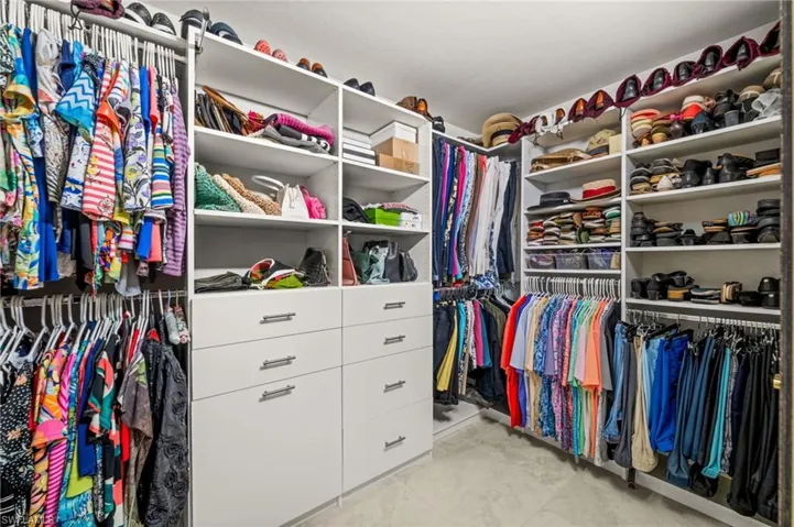 Walk in closet with light tile patterned floors