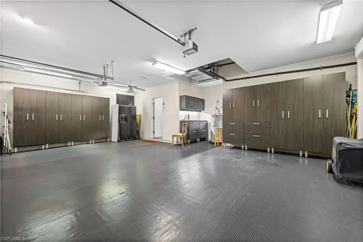 Garage with custom cabinets and vinyl floor