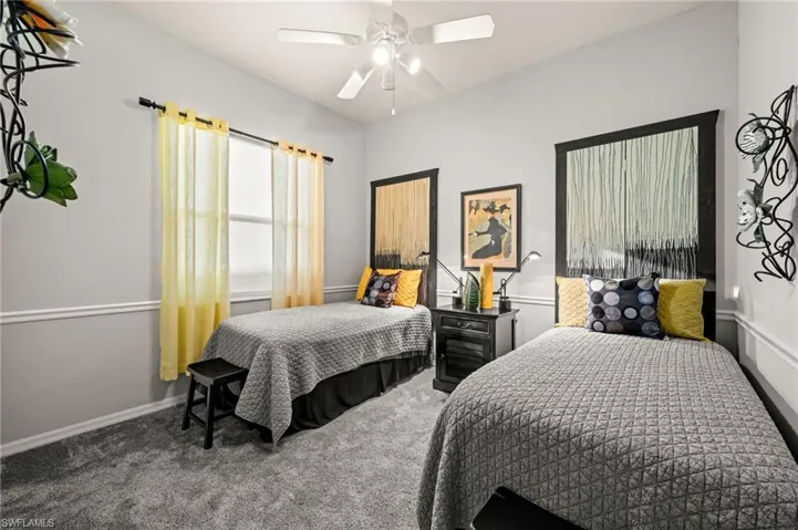 Bedroom featuring ceiling fan and carpet