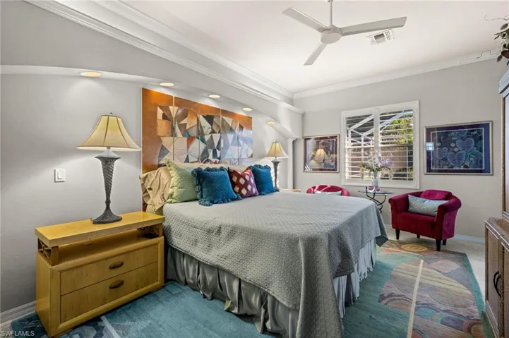 Primary Bedroom with crown molding, a ceiling fan, and carpet