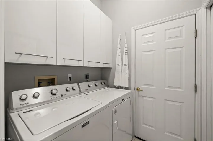 Laundry area with cabinet space and independent washer and dryer