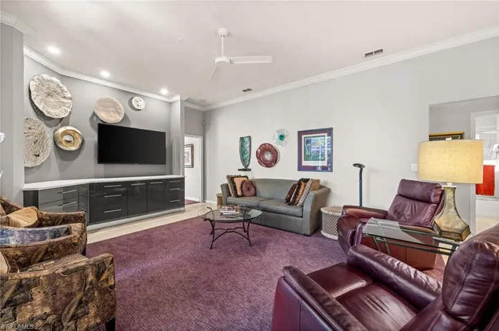 Living area featuring crown molding, a ceiling fan, and recessed lighting