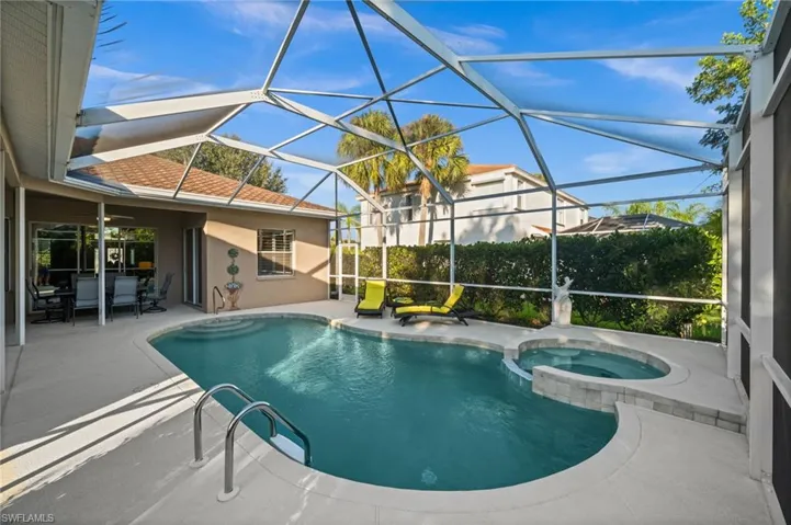 View of swimming pool featuring, patio, a pool with connected hot tub